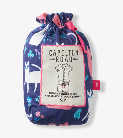 Folded navy pajama set bag with pink trim and cat print, labeled women's short PJ set.
