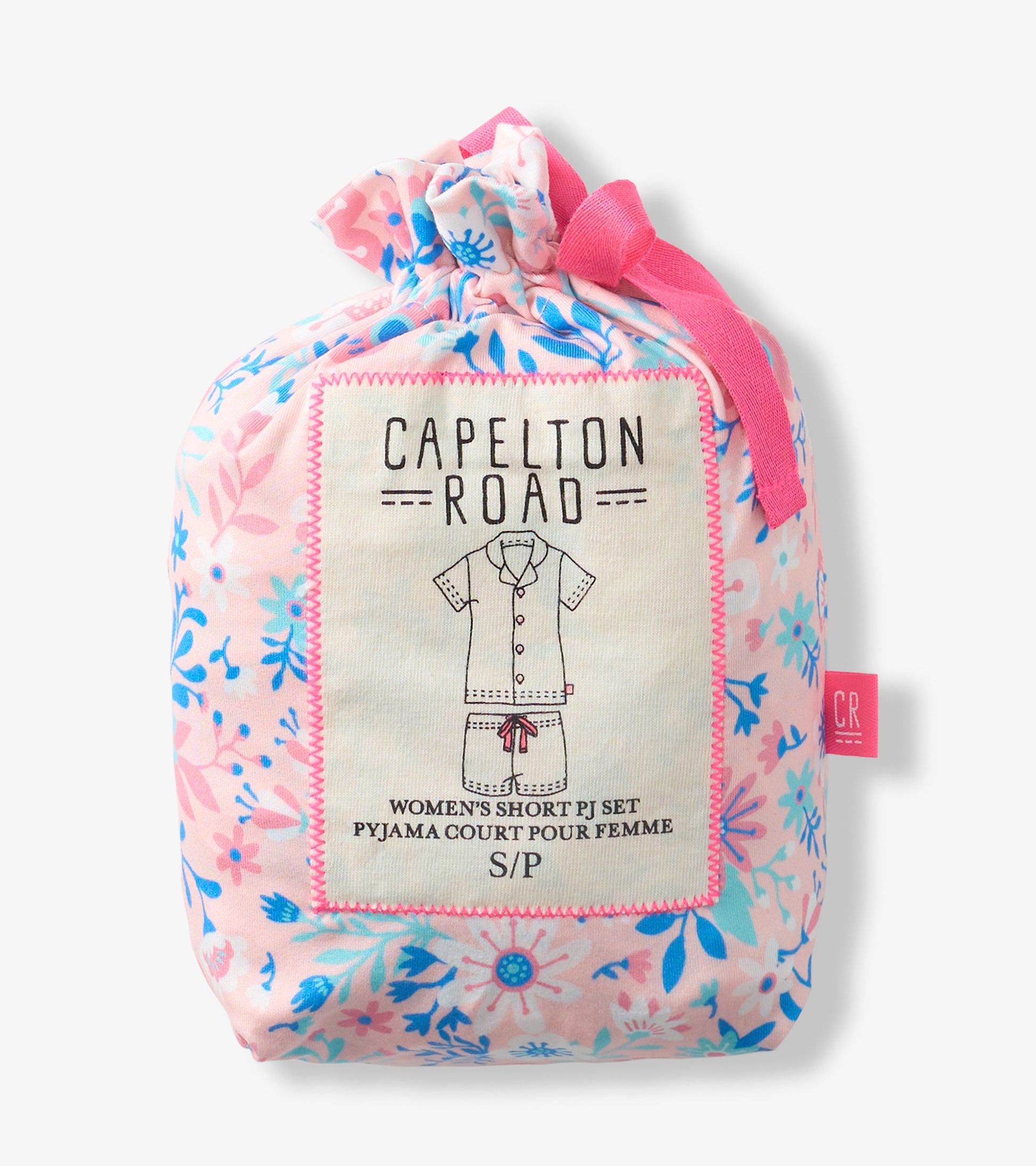 Pink floral pajama set in a drawstring pouch with a button-down top and shorts illustration on the label