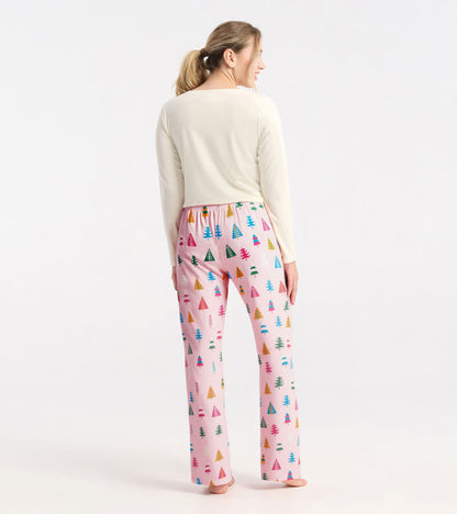Pink polyknit pajama pants featuring colorful holiday tree patterns, with an elastic waistband and a relaxed fit.