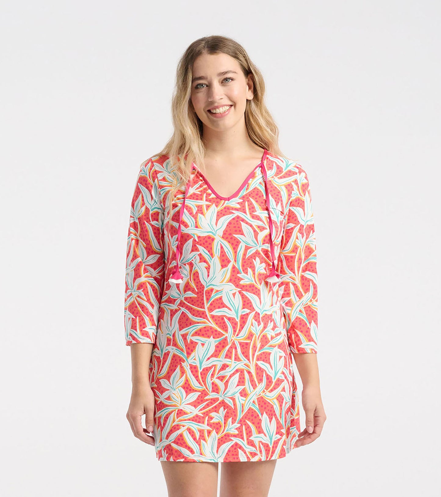 Short-sleeve beach dress featuring a vibrant pink leafy floral pattern, perfect for summer outings.