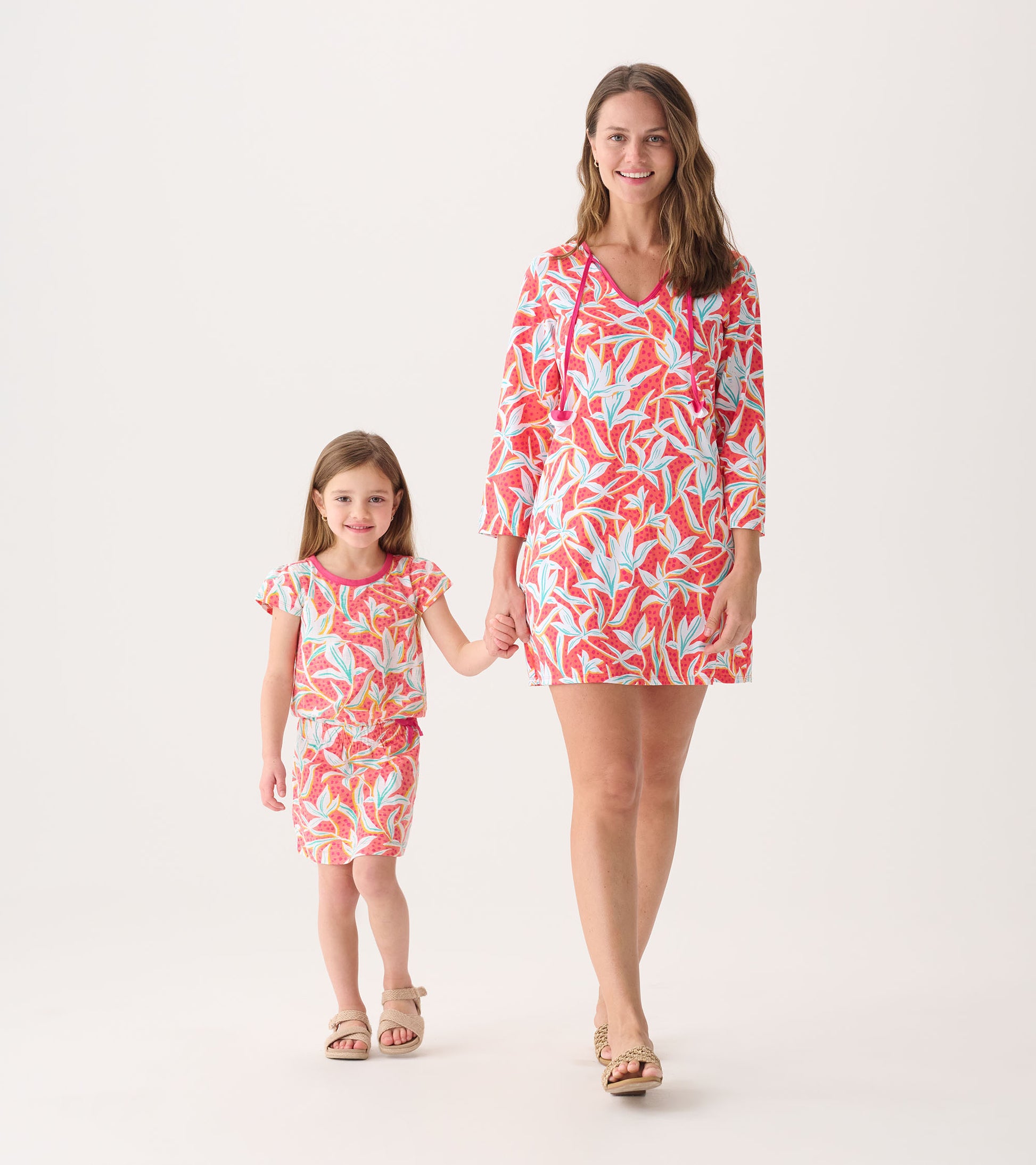 Floral beach dress in vibrant red and blue, featuring a V-neck and three-quarter sleeves, worn by a woman and girl.