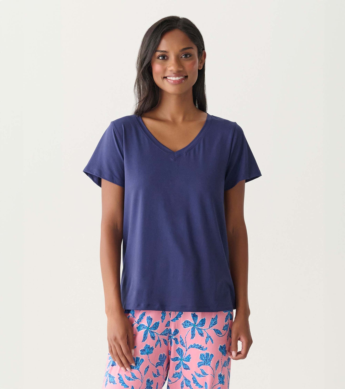 Navy short-sleeve V-neck polyknit T-shirt worn by a model, front view.
