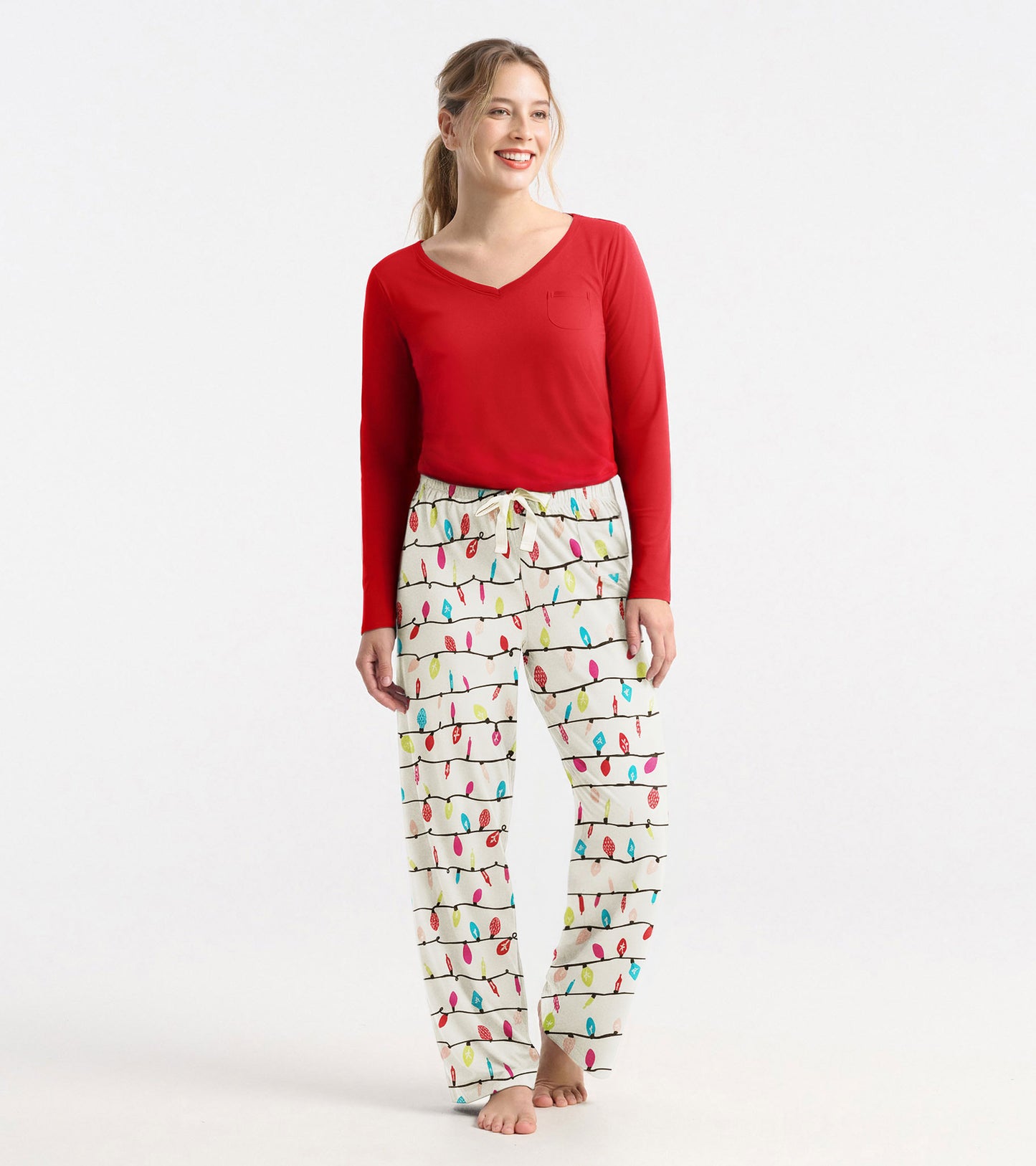Red long sleeve polyknit t-shirt with a V-neck and a chest pocket, styled with patterned pajama pants.