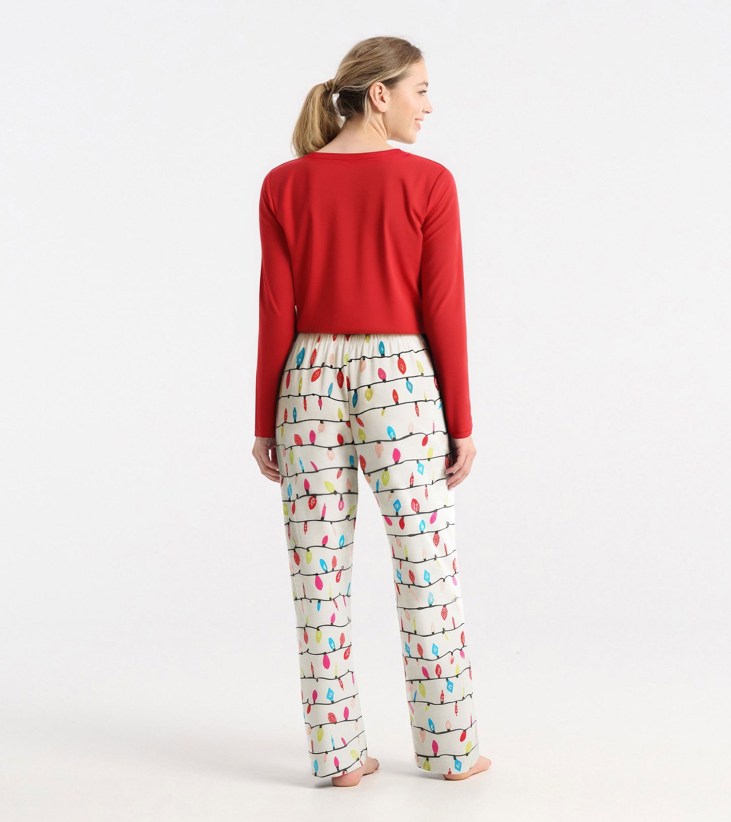 Red long sleeve polyknit t-shirt worn with patterned pajama pants featuring colorful light bulbs.