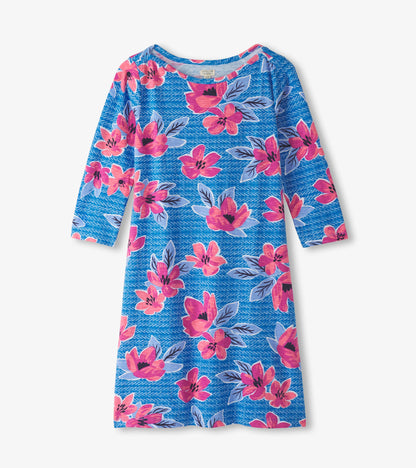 Blue dress featuring a bold floral pattern in pink and purple, with three-quarter sleeves and a bateau neckline.