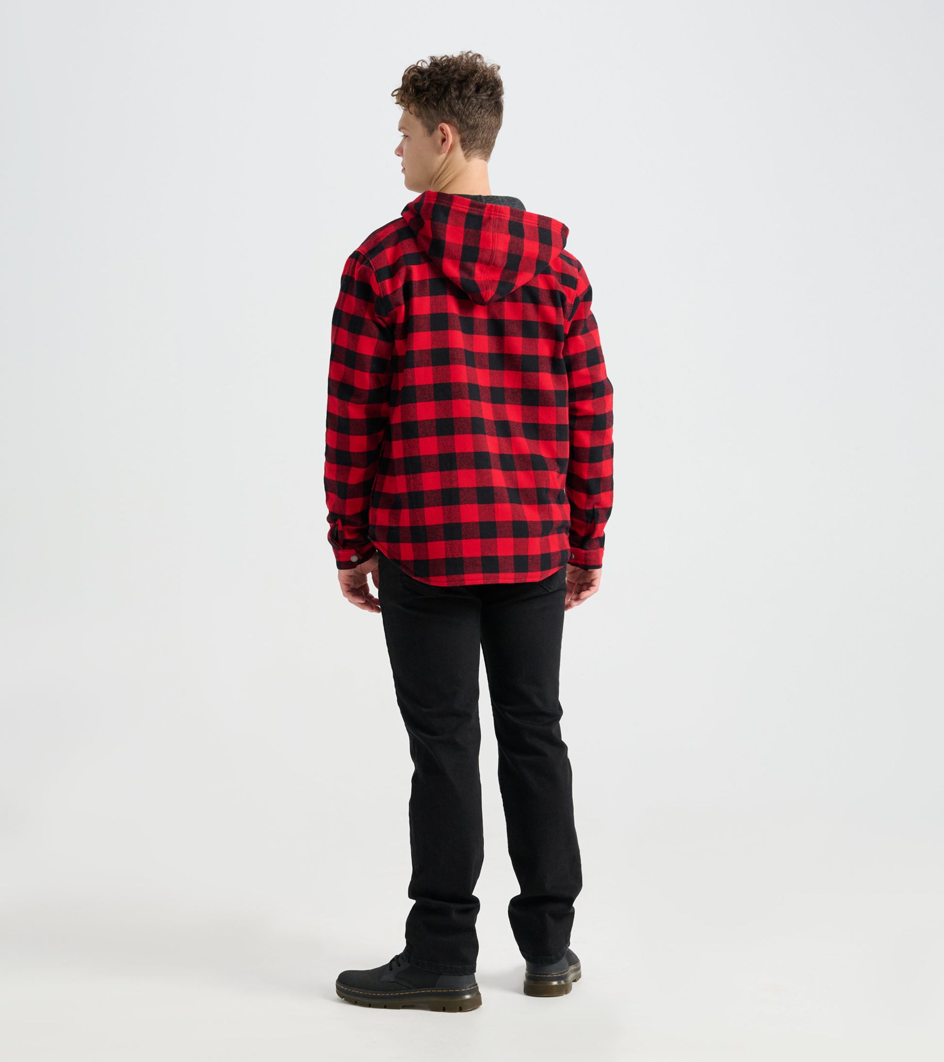 Red and black buffalo plaid flannel jacket with a hood, shown from the back, paired with black pants.