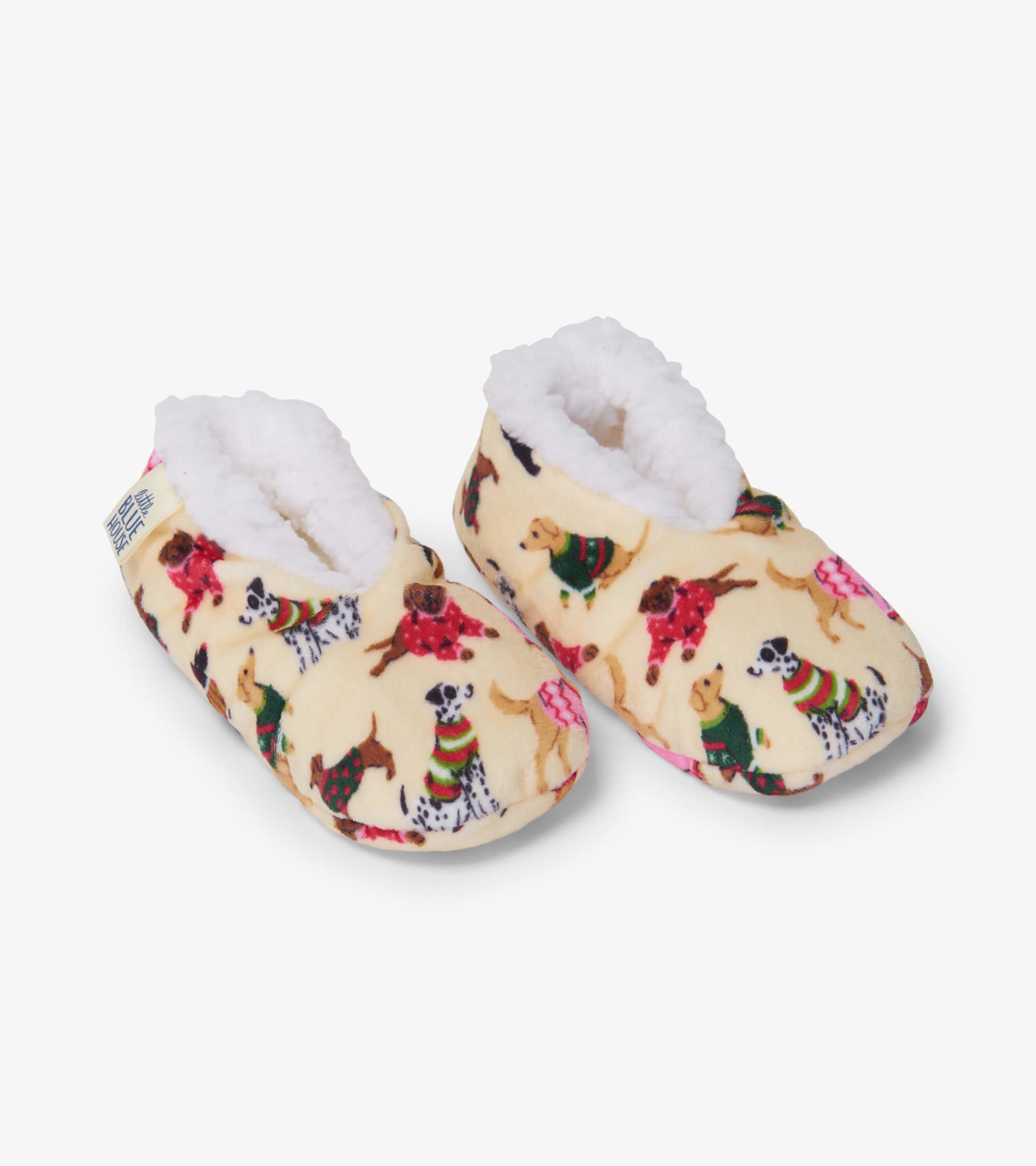 Cozy, cream-colored slippers with a playful dog pattern and soft, fluffy lining, perfect for kids.
