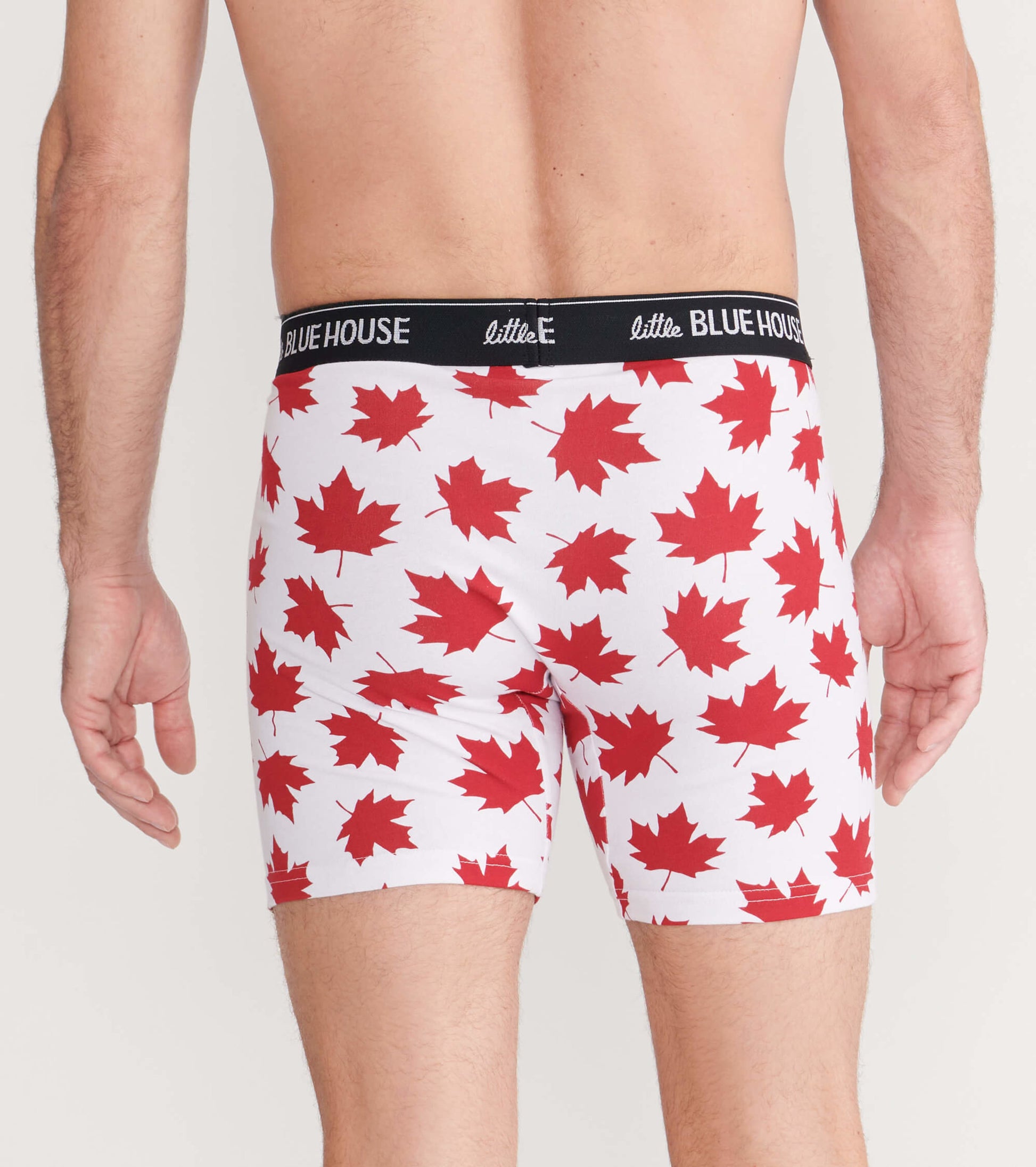 Men's boxer briefs in white with red maple leaf pattern, featuring a black waistband, shown from the back.