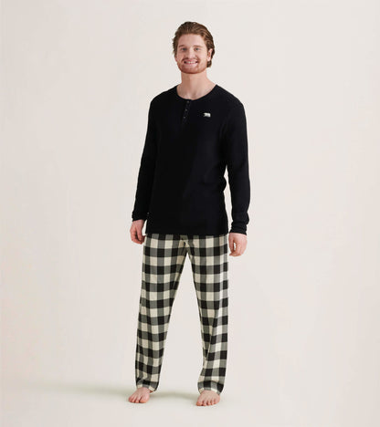 Men's black waffle henley shirt paired with black and white checkered pajama pants, standing barefoot.