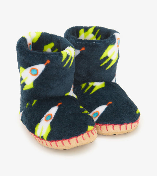 Navy fleece slippers featuring rocket patterns, with a soft interior and stitched soles for comfort.