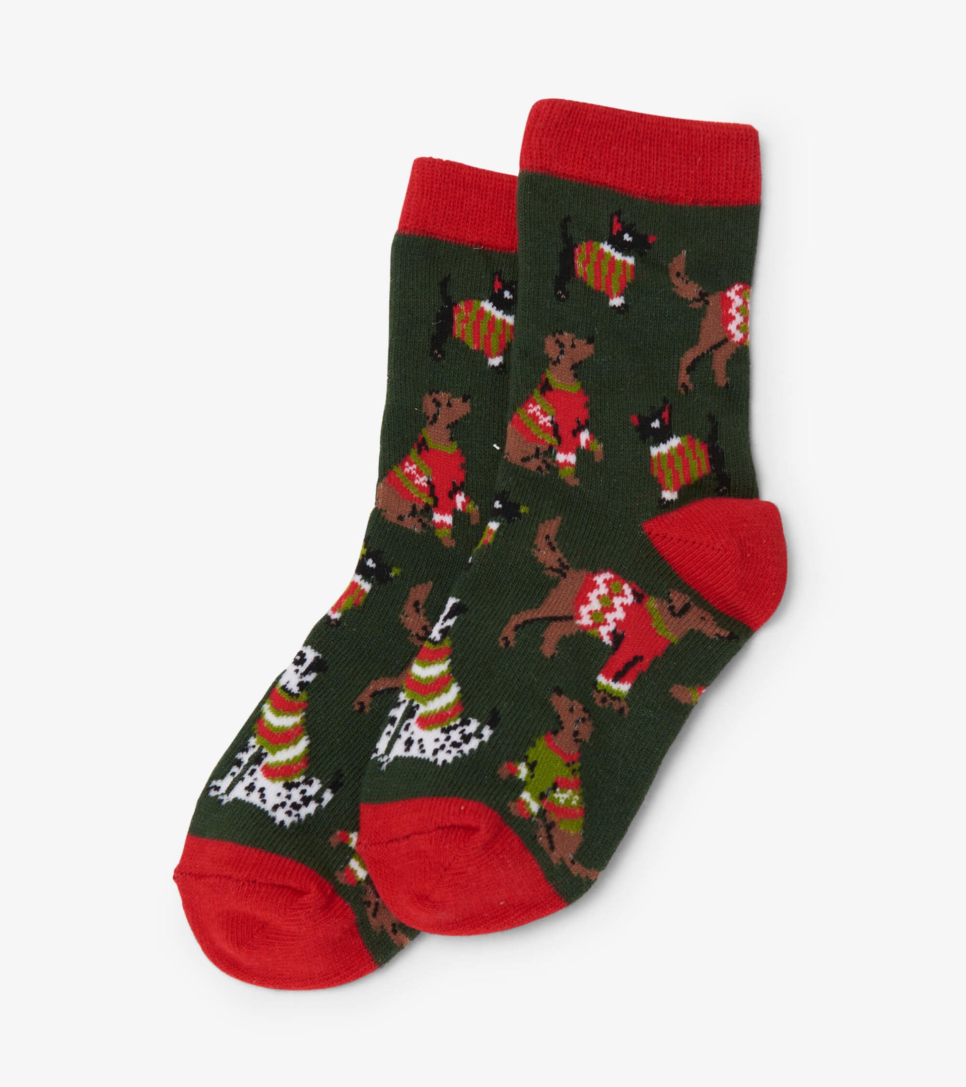 Green crew socks featuring playful dogs in festive sweaters, with red cuffs and toes. Suitable for kids ages 2-7.