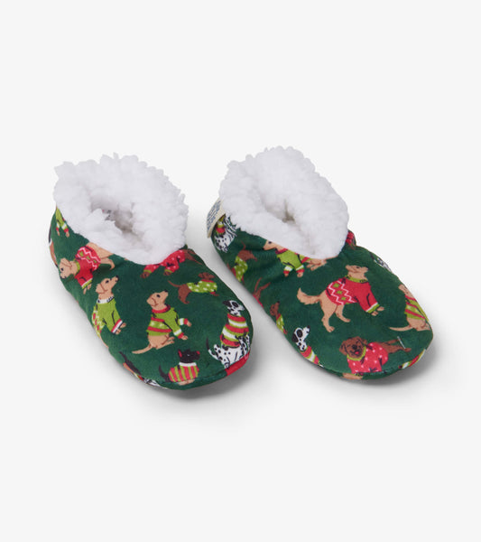 Green slippers featuring a cozy white lining and playful dog patterns, perfect for keeping kids warm during winter.