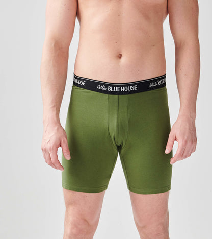 Green men's boxer briefs with a black waistband, featuring a snug fit and a front opening.