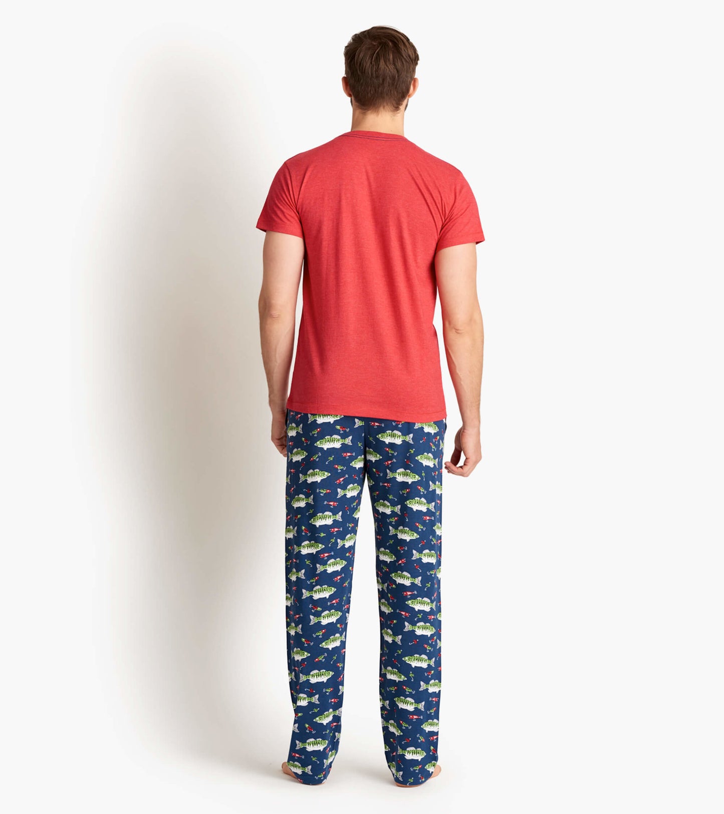 Red short-sleeve men's tee worn with patterned blue pajama pants featuring fish designs, viewed from the back.