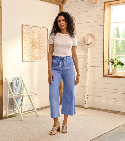 Light blue chambray tie front pants with wide legs, styled with a casual top and heeled sandals.
