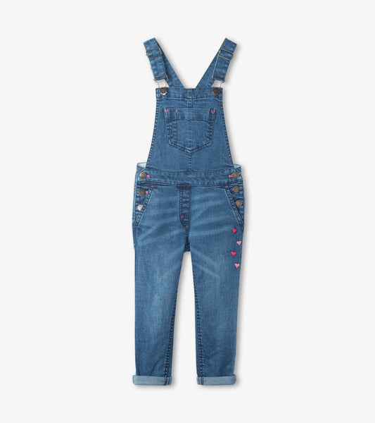 Blue denim overalls with adjustable straps, front pockets, and heart-shaped embroidery on the side.