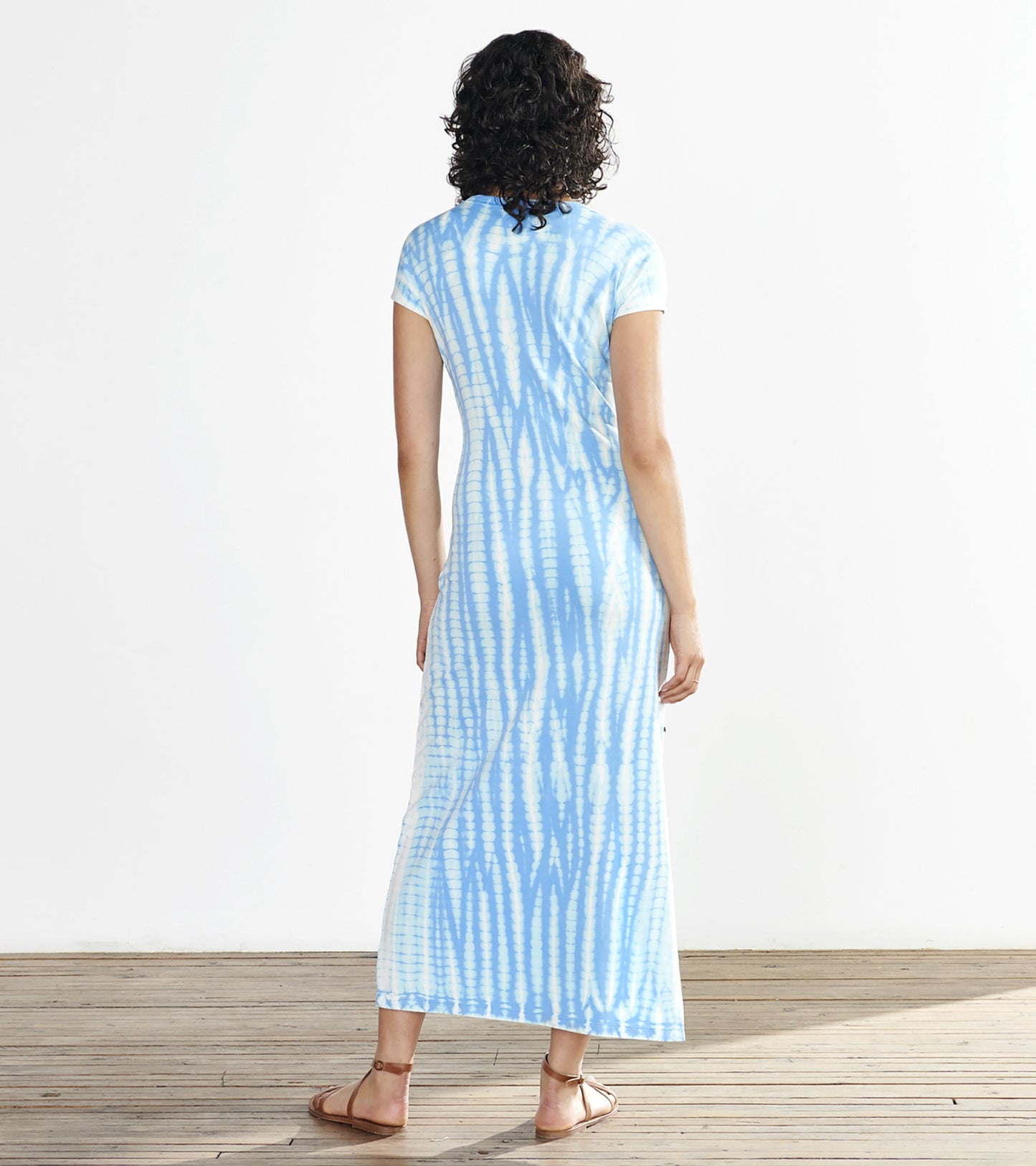 Maxi dress in azure tie-dye pattern with short sleeves, shown from the back.