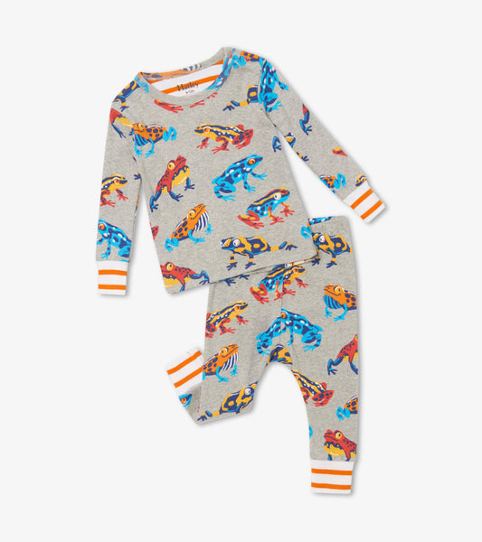 Gray organic cotton baby pajama set featuring colorful leaping frogs, with striped orange cuffs on the top and pants.