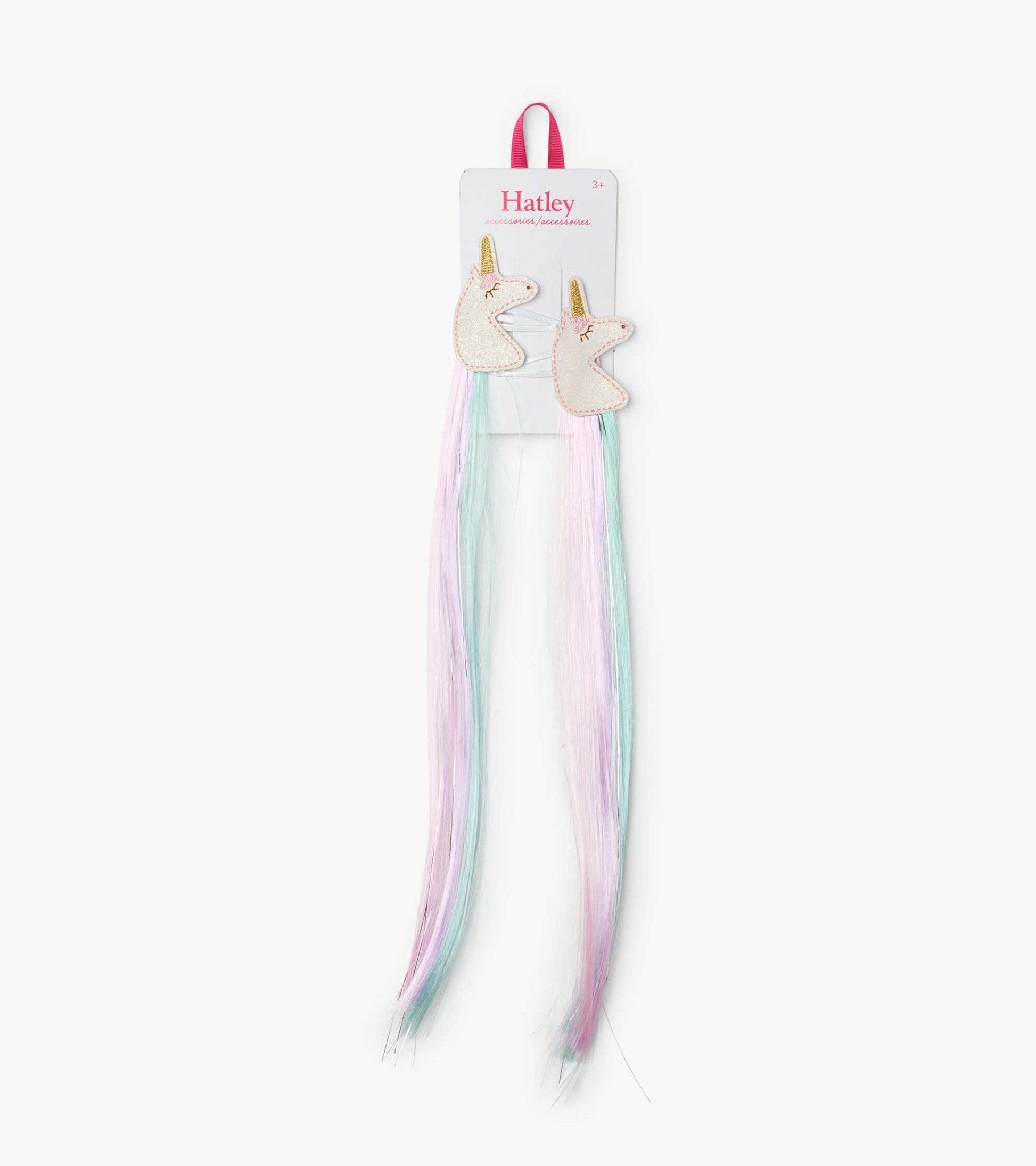 Two unicorn-shaped hair clips with pastel pink and blue faux hair extensions. Ideal for playful hairstyles.