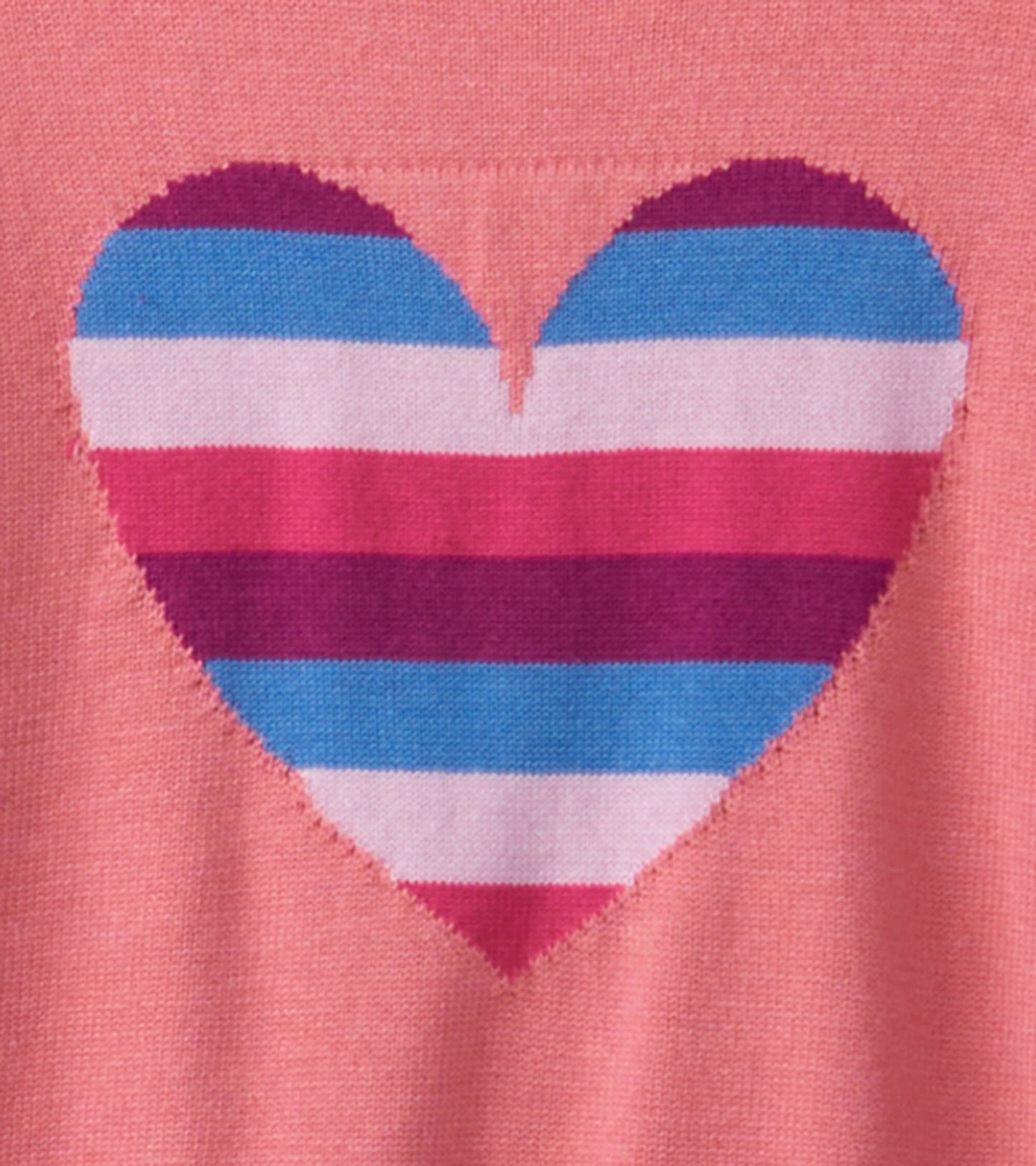 Pink sweater featuring a striped heart design in blue, pink, and purple with ruffle sleeves.