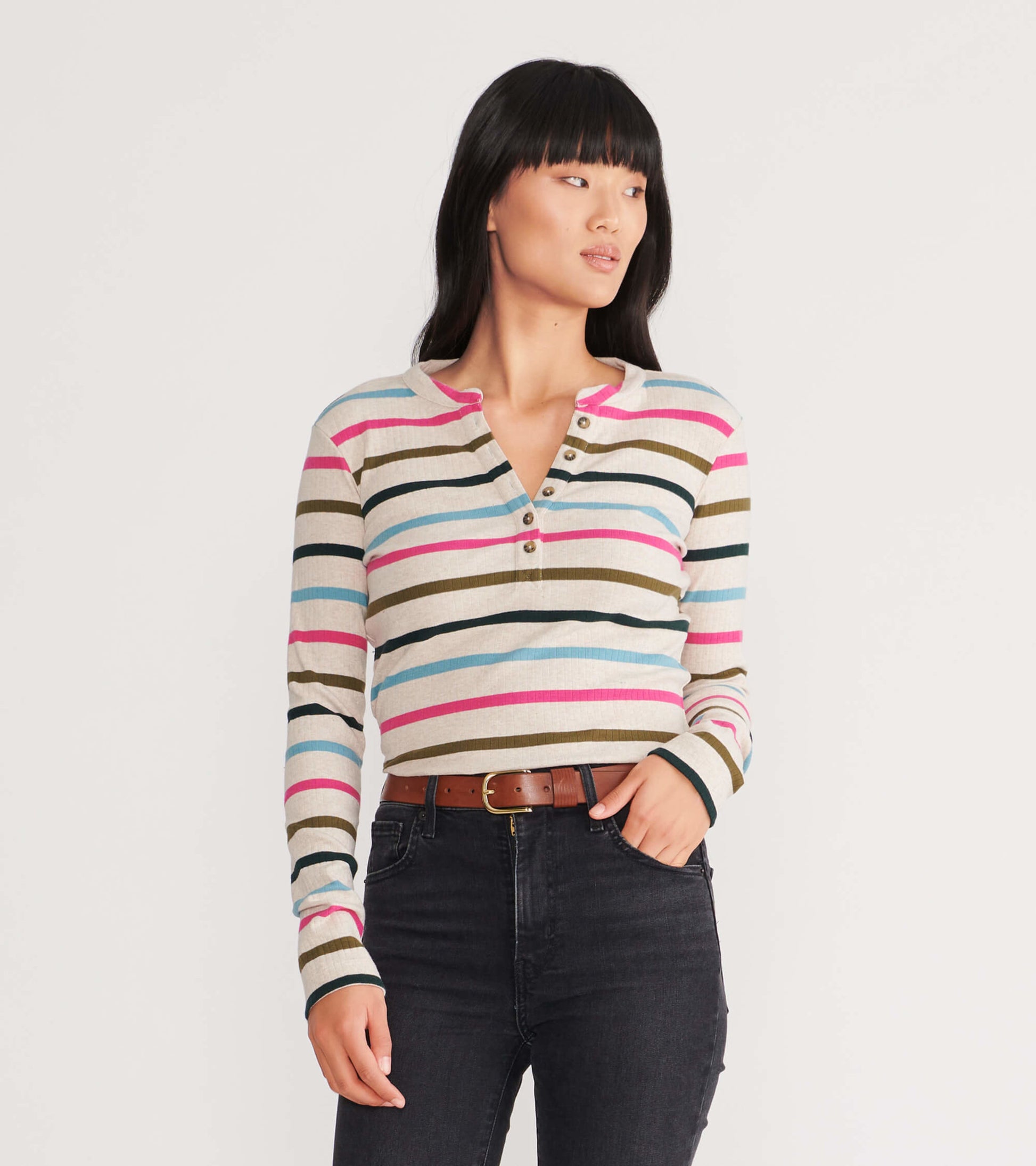 Long-sleeve henley top featuring multicolored stripes on a light background, with a buttoned neckline and fitted silhouette.