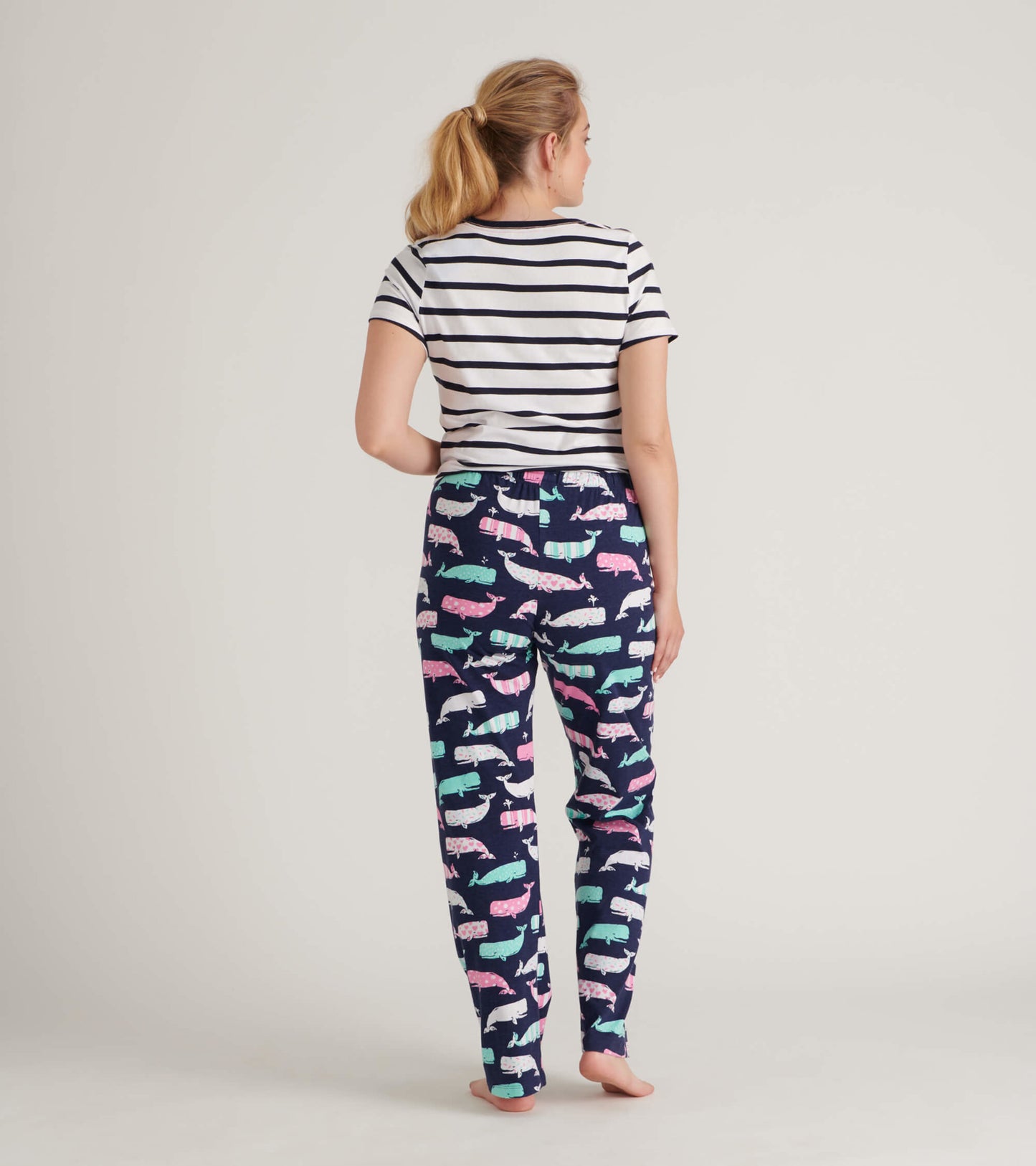 Striped short-sleeve tee paired with whale-patterned pajama pants in navy, showcasing a playful design.