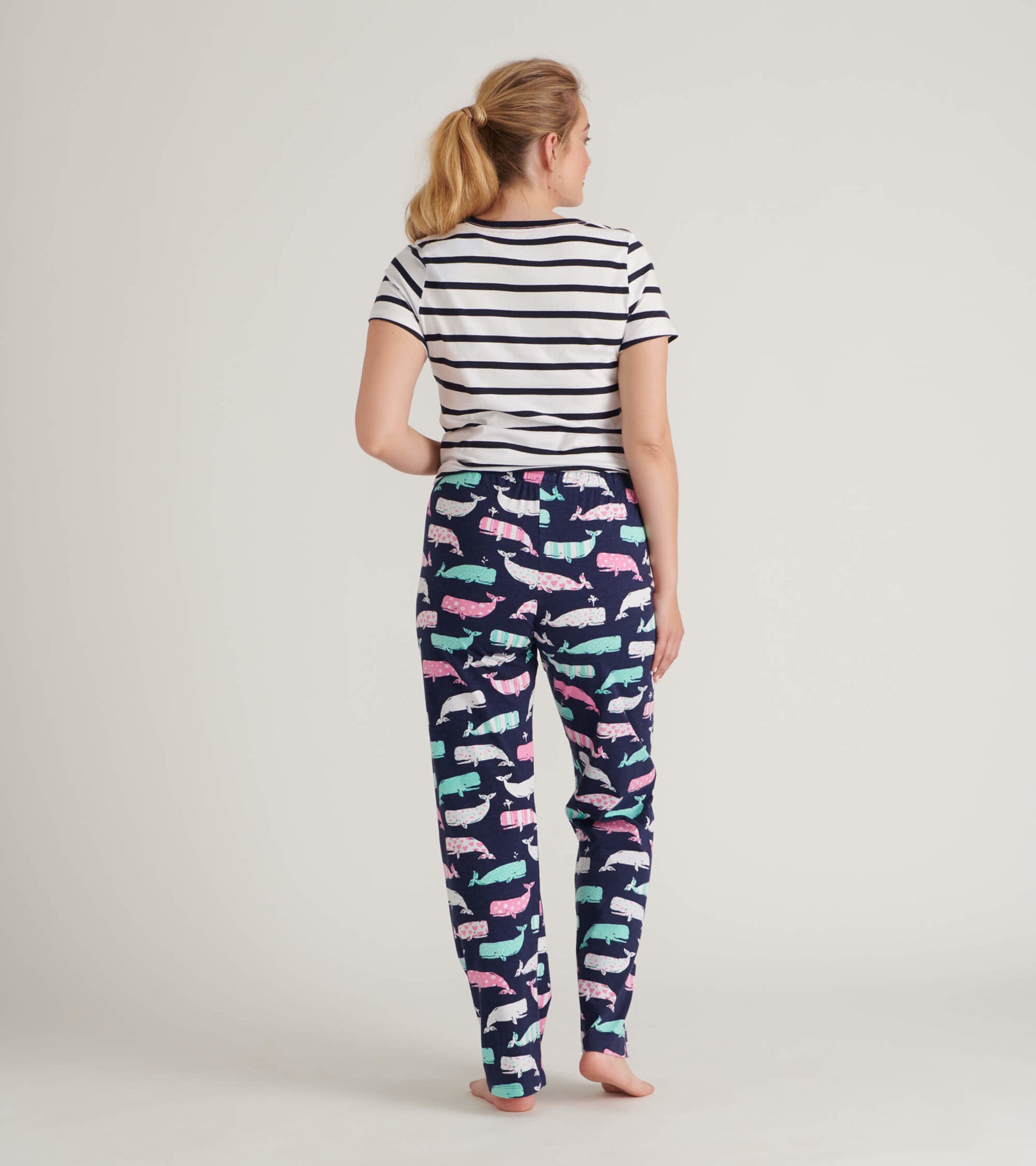 Striped short-sleeve tee paired with whale-patterned pajama pants in navy, showcasing a playful design.