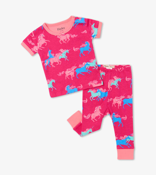 Pink organic cotton baby pajamas featuring a playful unicorn pattern, with short sleeves and matching pants.