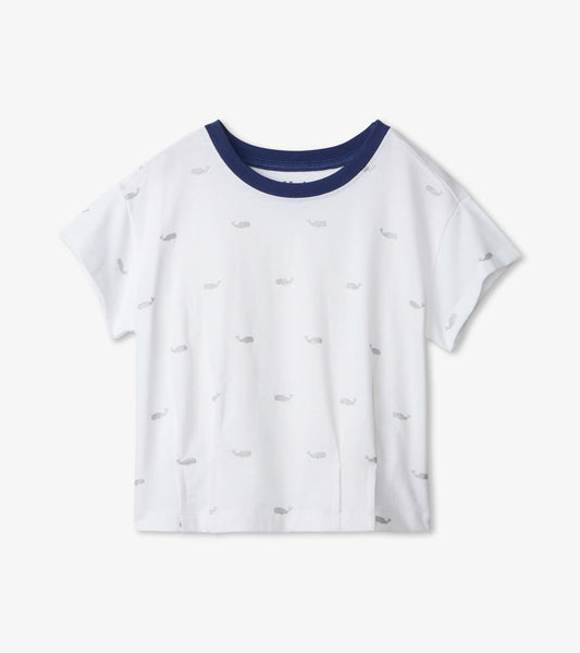 White slouchy tee with a navy collar, featuring a playful whale pattern in gray. Short sleeves and relaxed fit.