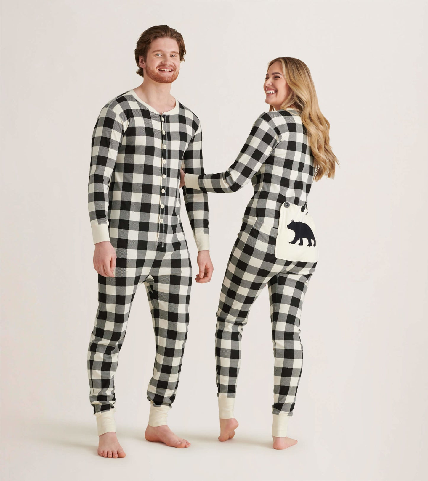 Cream plaid adult onesie featuring a button front and bear pocket detail, suitable for cozy lounging.