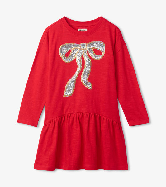 Red long-sleeve party dress featuring a sequined bow design and a flared skirt. Ideal for holiday celebrations.