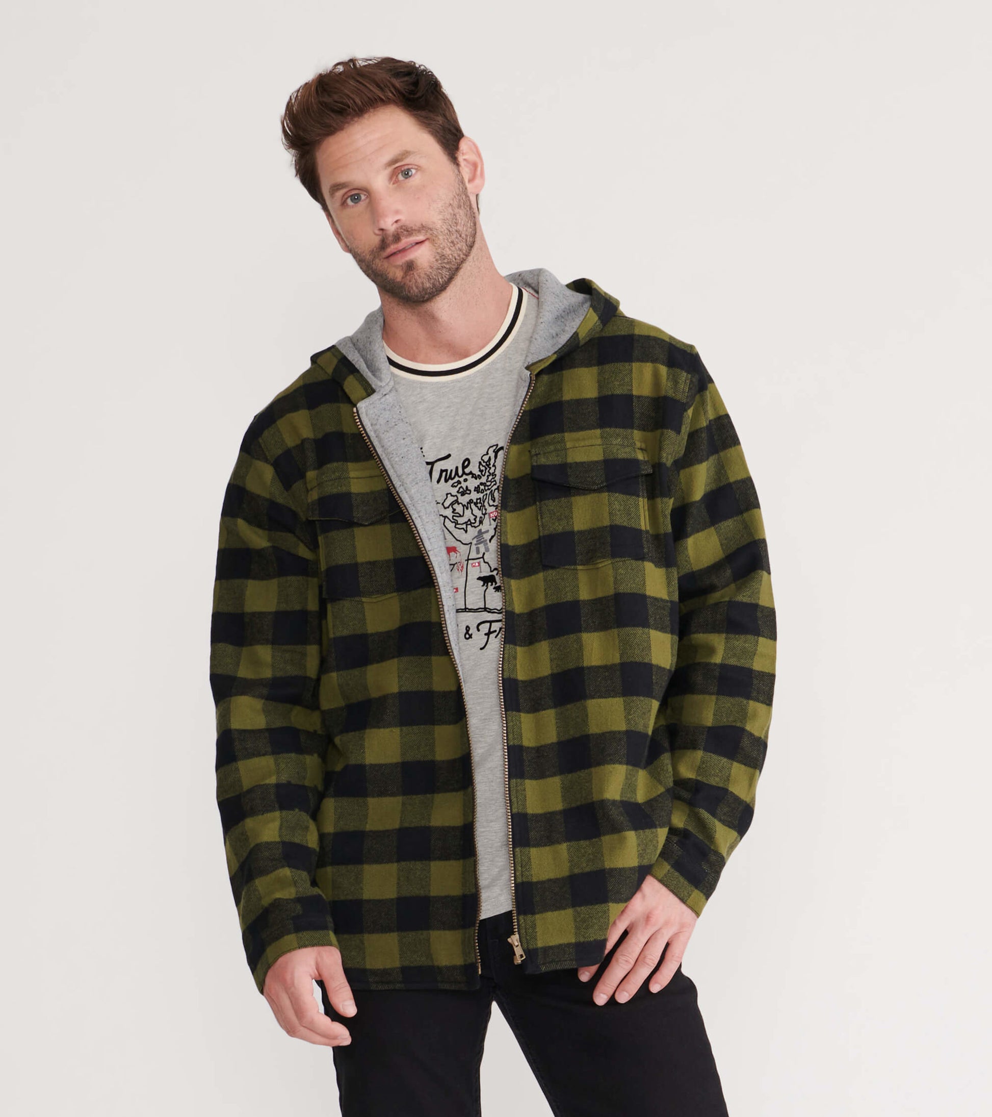 Green and black plaid flannel jacket with a zip front and hood, worn over a gray graphic t-shirt.
