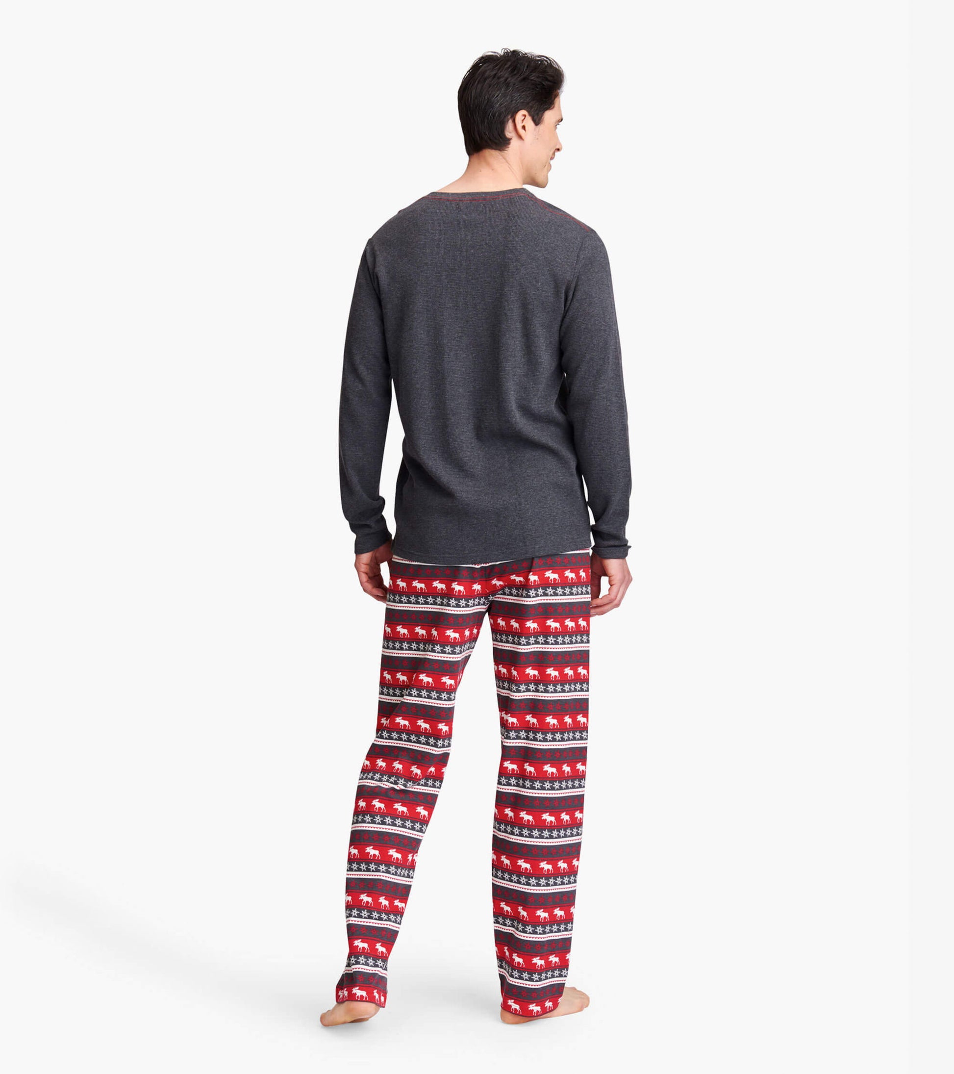 Men's pajama pants in red with Fair Isle moose pattern, made of stretch cotton, shown from the back.
