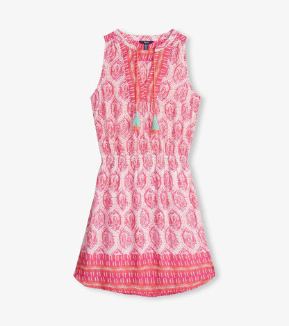 Sleeveless pink dress featuring a geo mosaic pattern and tassel details, cinched at the waist for a flattering fit.