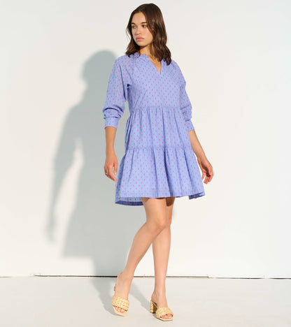 Pink clip dot dress with a tiered skirt and three-quarter sleeves, featuring a V-neckline and relaxed fit.