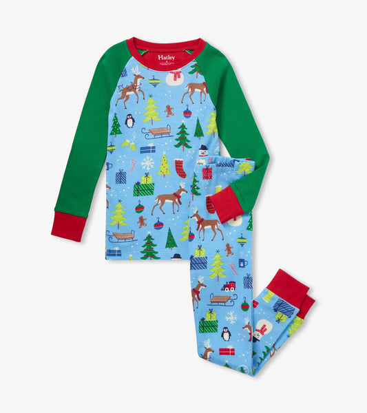Blue organic cotton pajama set with festive patterns, featuring green sleeves and red cuffs, suitable for kids.