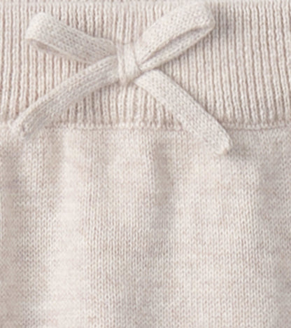 Light beige oatmeal sweater pants with a ribbed waistband and a decorative bow detail. Suitable for babies 0-9 months.