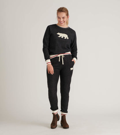 Black pullover with a cream bear graphic, featuring ribbed cuffs and a drawstring waist, styled with matching pants.