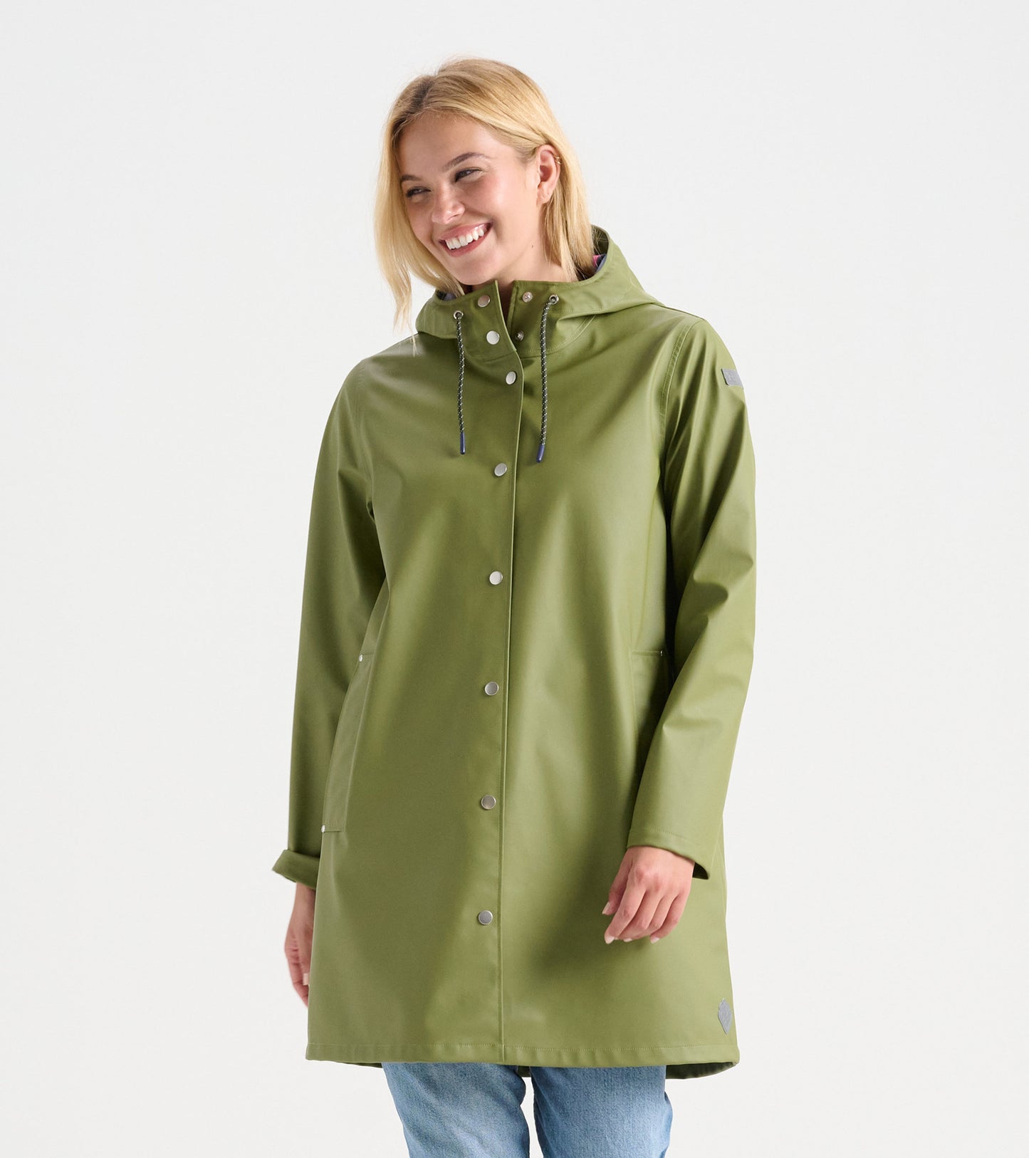 Loden green rain jacket with a hood, snap buttons, and side pockets, worn by a smiling woman.