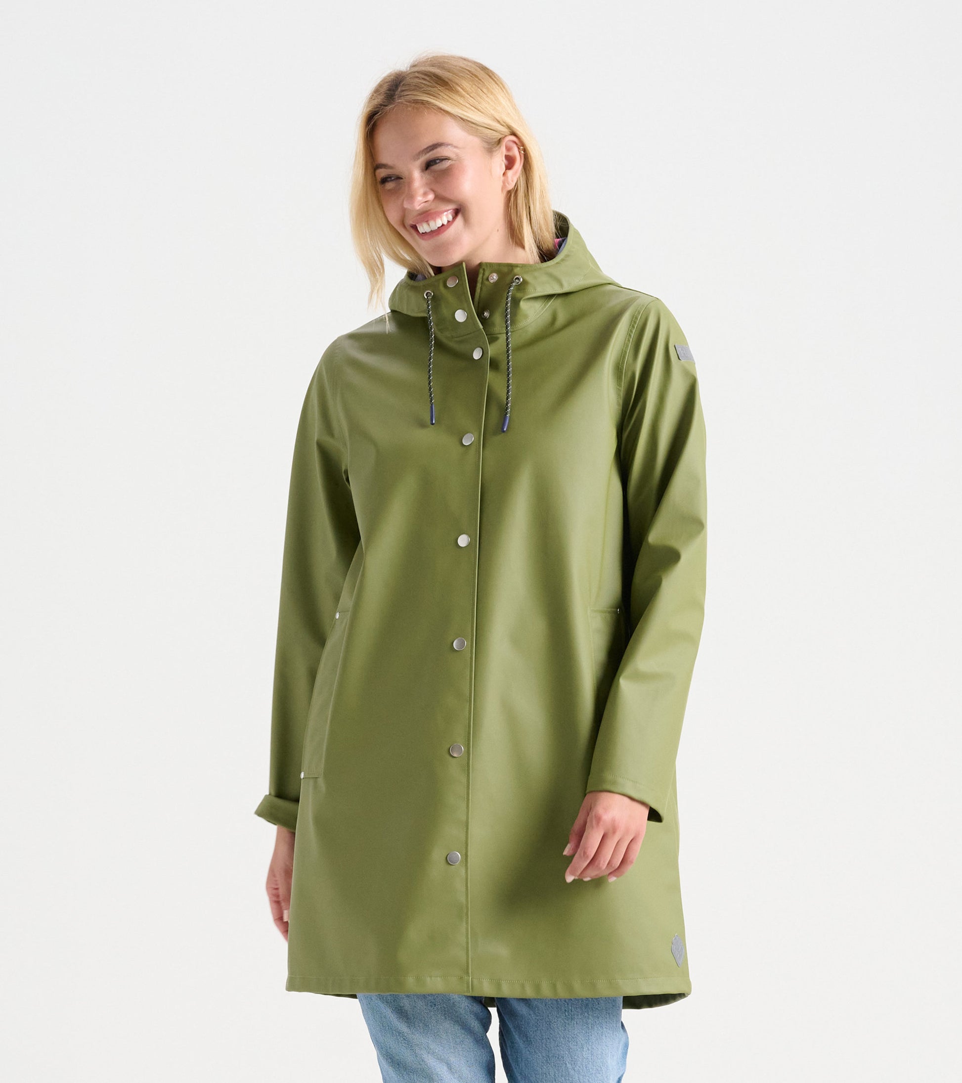 Loden green rain jacket with a hood, snap buttons, and side pockets, worn by a smiling woman.