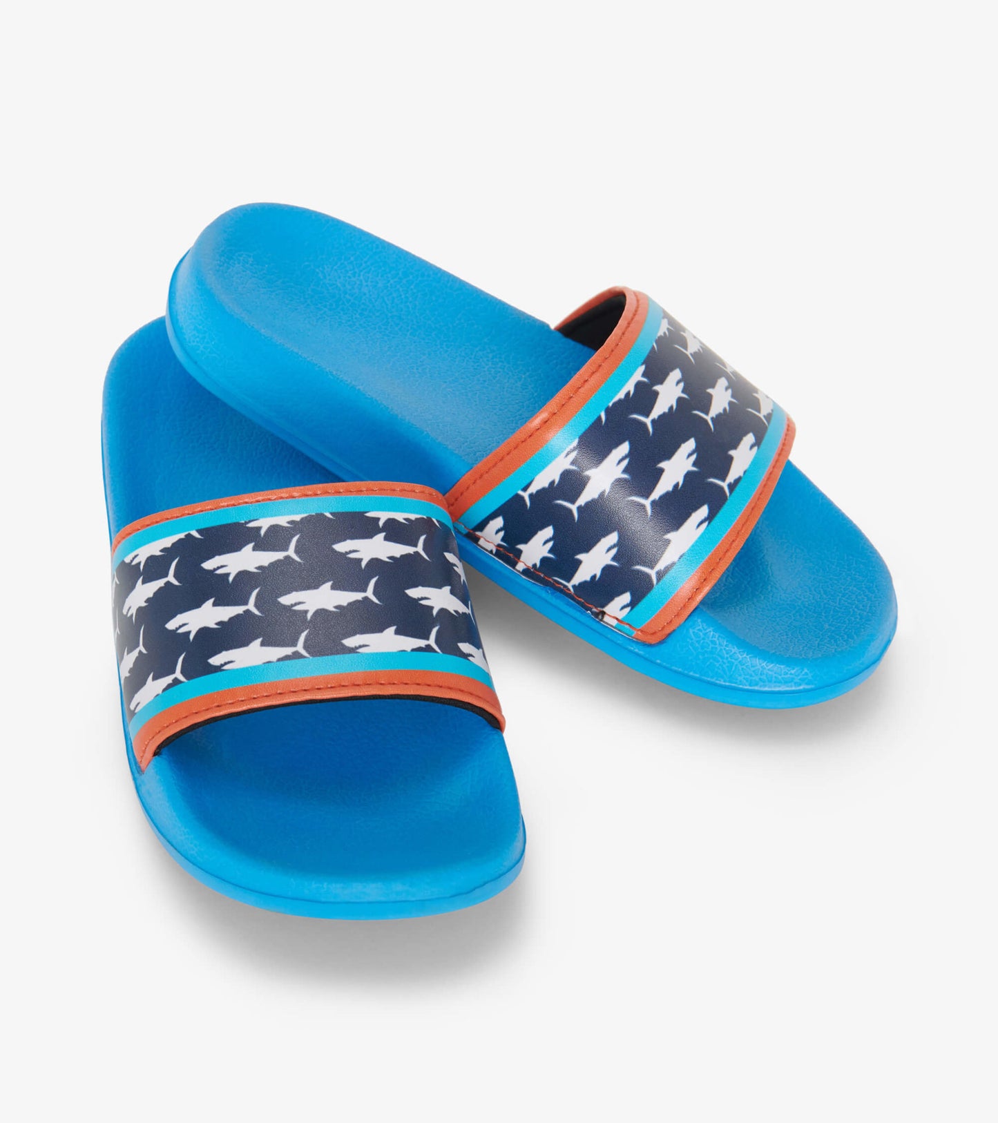 Blue slide sandals featuring a shark print strap with orange and turquoise accents. Ideal for casual wear.