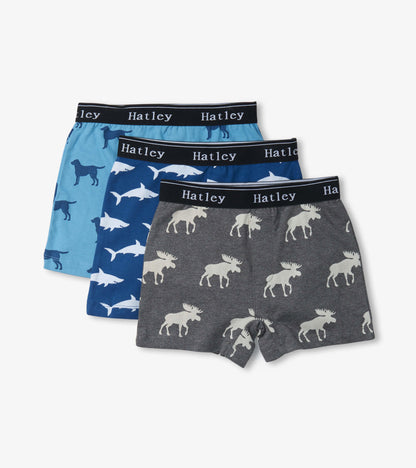 Three pairs of boys' boxer briefs featuring animal silhouettes in blue and gray tones with elastic waistbands.