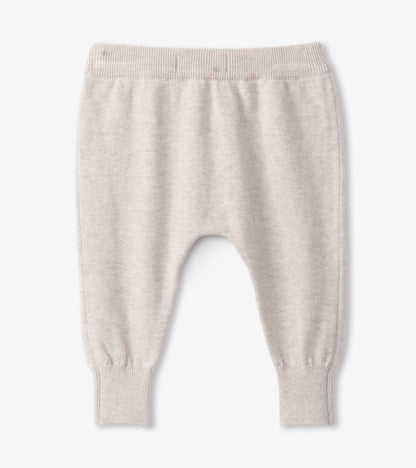 Light beige pull-on sweater pants for babies, featuring a soft knit material and ribbed cuffs. Suitable for ages 0-9 months.
