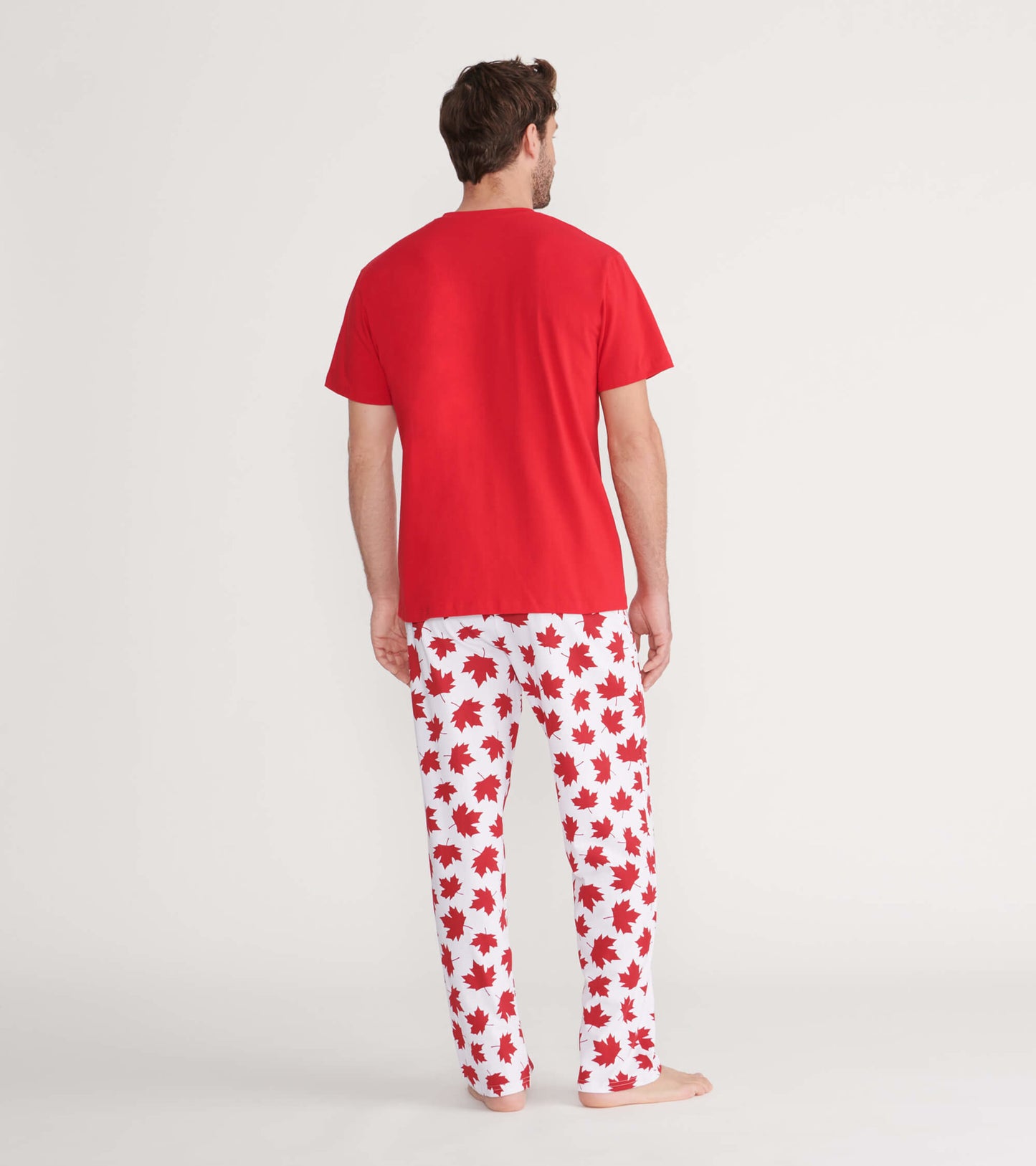Men's pajama pants in white with red maple leaf pattern, made of stretch cotton, shown from the back.