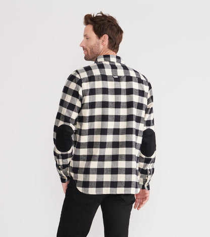 Black and white plaid flannel shirt with elbow patches, shown from the back on a model.
