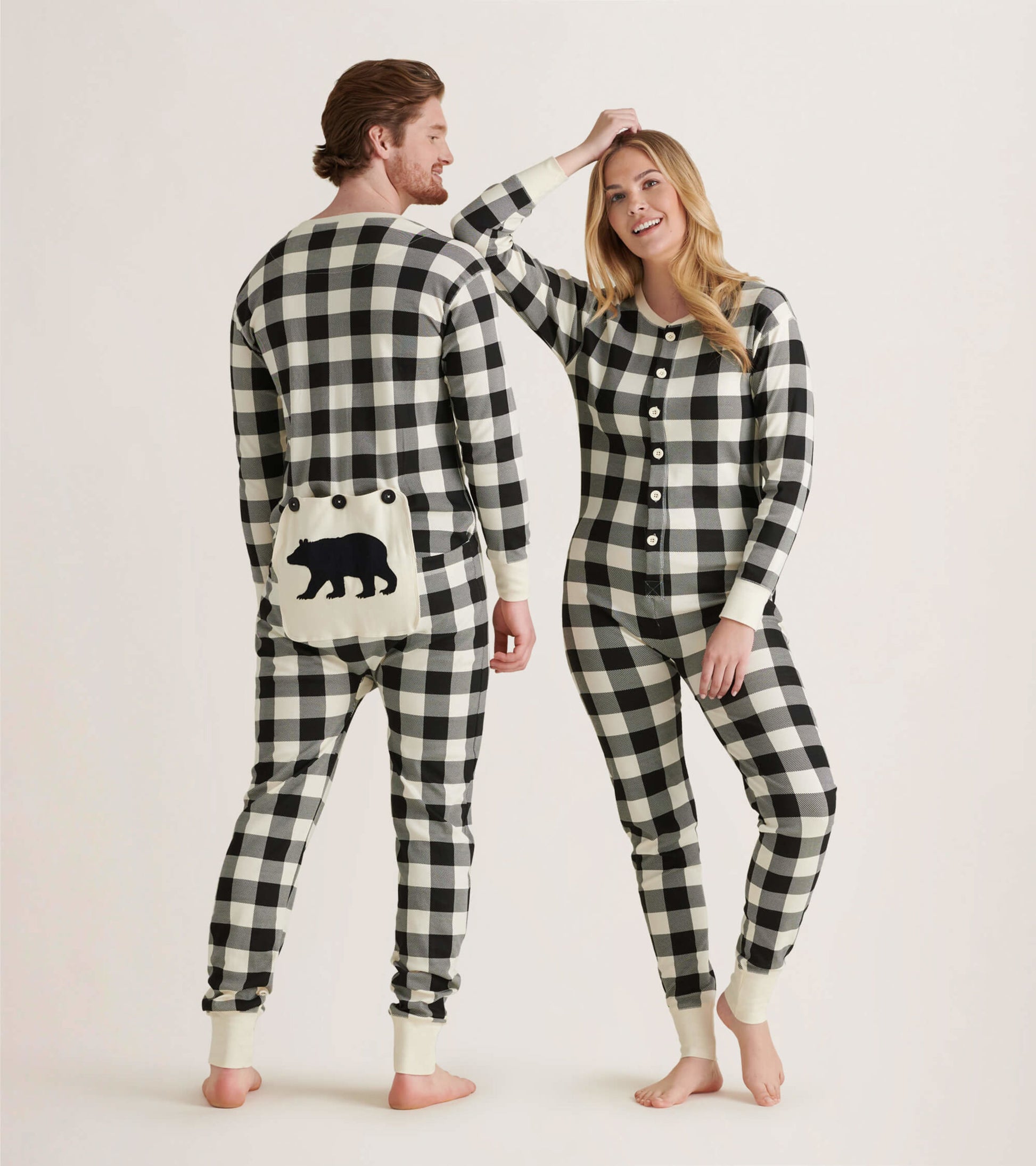 Cream plaid adult onesie featuring a bear design on the back, with button closure and ribbed cuffs.