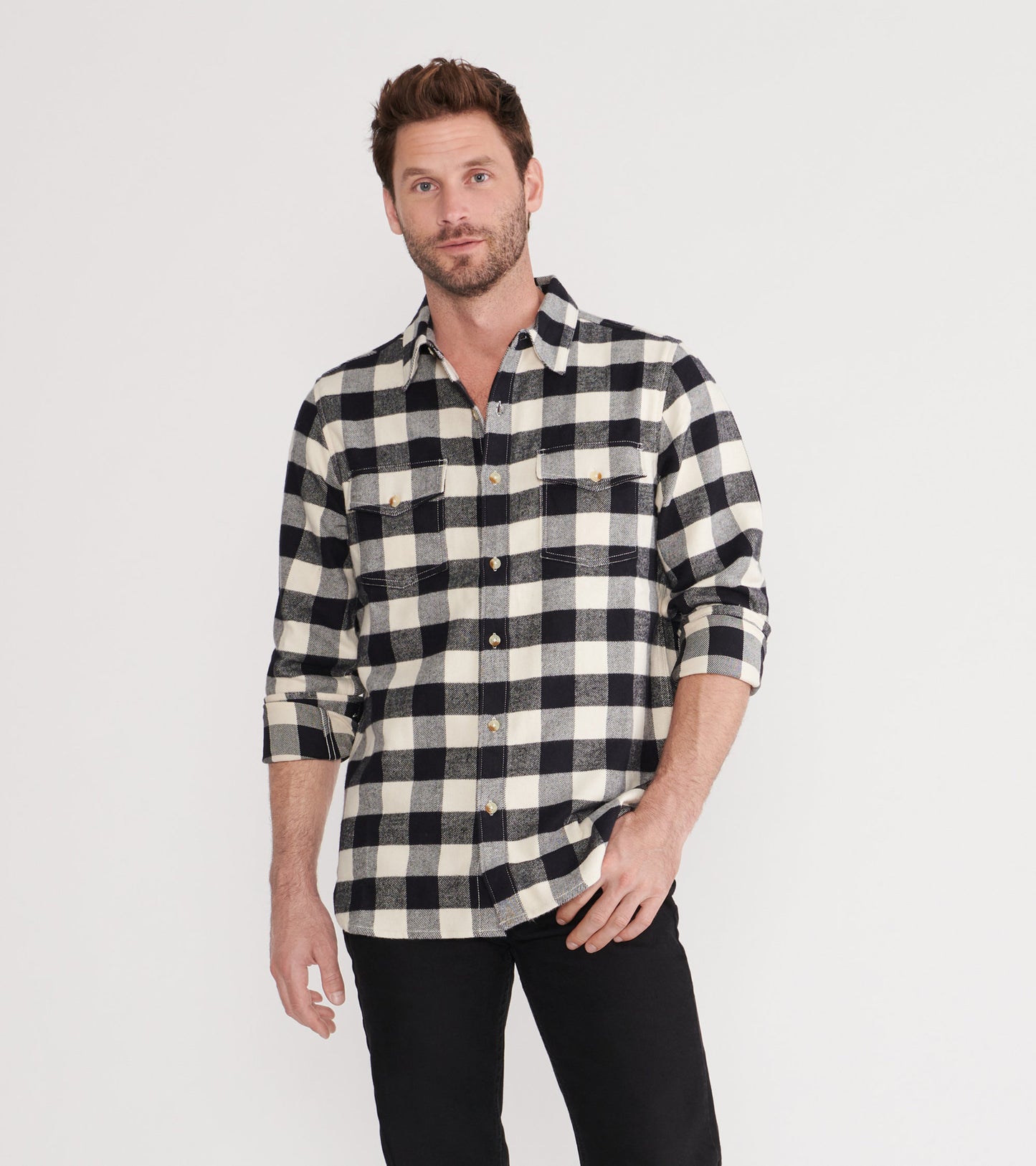 Black and cream plaid flannel shirt with long sleeves and two chest pockets, styled casually.