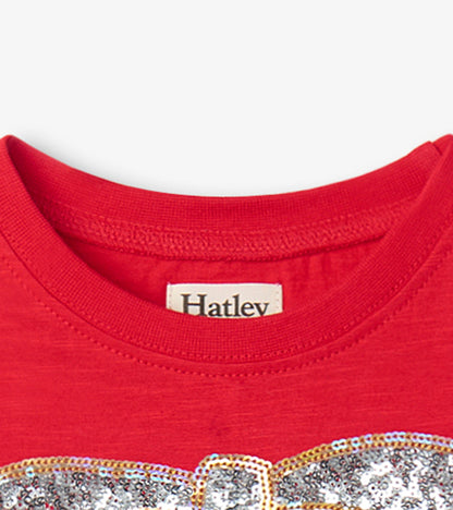 Red holiday dress featuring a sparkly bow design and a classic crew neckline.
