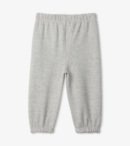 Light grey French terry baby joggers with an elastic waistband and gathered cuffs. Suitable for infants.