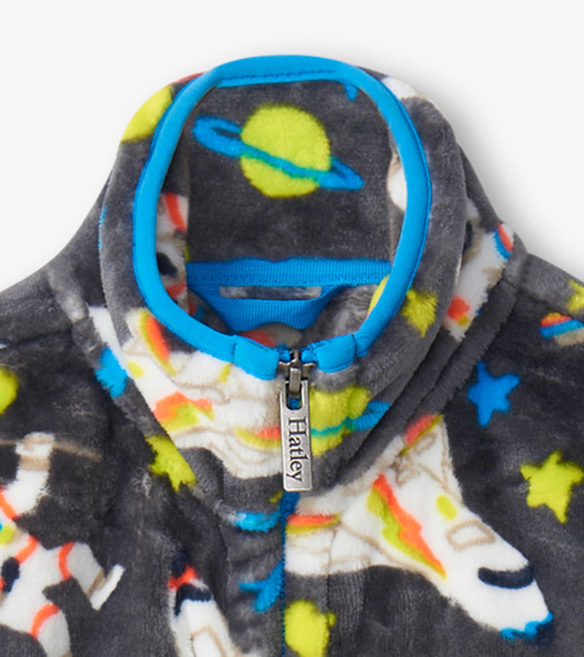 Gray fleece jacket featuring colorful astronaut and planet patterns, with a blue zippered collar.